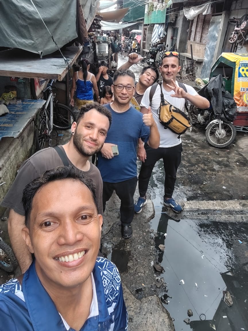 Ryan guiding international visitors on a Tondo walking tour in Manila